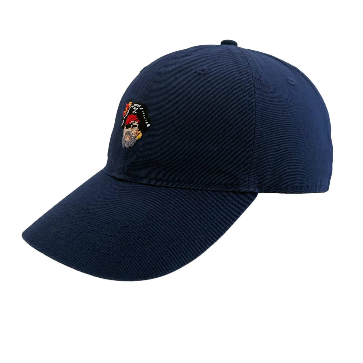 Side angle of Pirate Needlepoint Hat by Smathers & Branson showing needlepoint skull design and cotton twill construction.